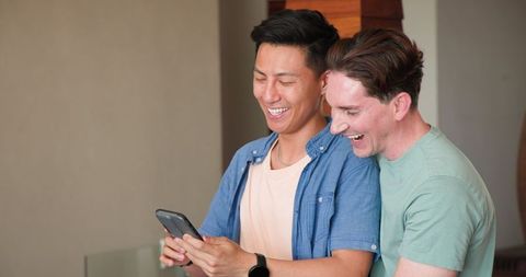 Joyful Couple Sharing Moments on Smartphone at Home, Happy Together