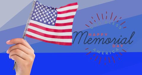 American Flag in Hand Celebrating Memorial Day with Blue Tones
