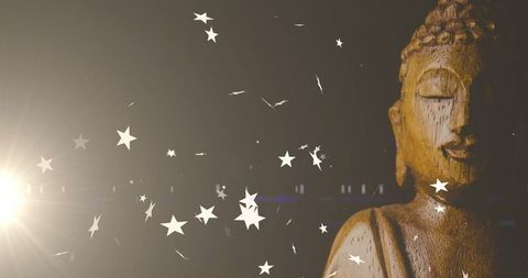 Wooden Buddha Statue with Star Particles and Lens Flare for Spiritual Serenity