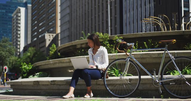 Businesswoman Working on Laptop Outside Urban Building - Download Free Stock Images Pikwizard.com