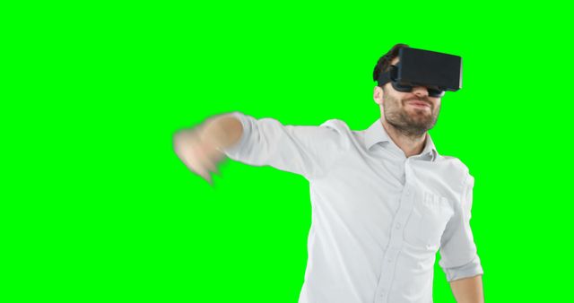 Man Immersed in Virtual Reality with VR Headset and Green Background - Download Free Stock Images Pikwizard.com