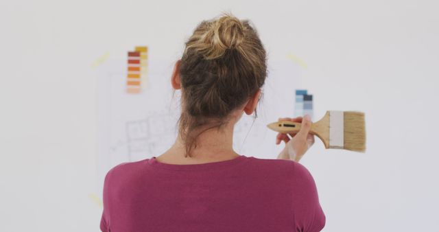 Woman Painting Wall with Color Swatches Behind - Download Free Stock Images Pikwizard.com