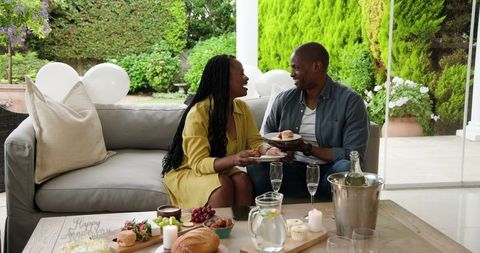 Happy Couple Enjoying Outdoor Brunch on Patio