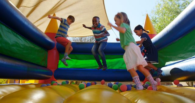Children Playing and Jumping on Inflatable Bounce House at Outdoor Playground - Download Free Stock Images Pikwizard.com