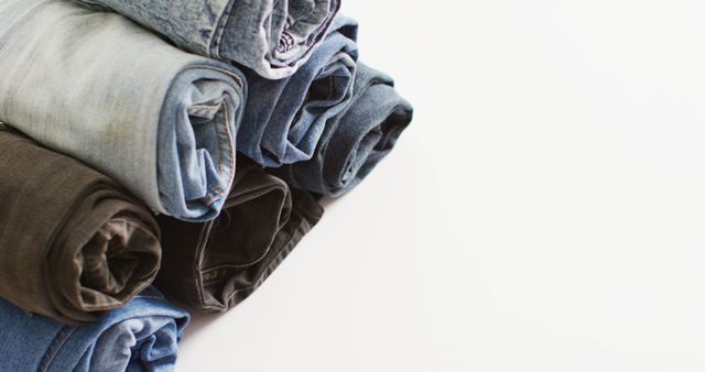 Close up of folded jeans with different shades on white background with copy space - Download Free Stock Photos Pikwizard.com