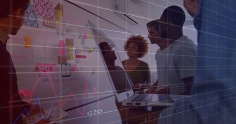 Diverse team collaborating on business data with digital overlay