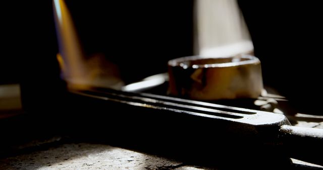 Close-Up of Illuminated Metal Foundry Tool and Molten Metal Pourer - Download Free Stock Images Pikwizard.com