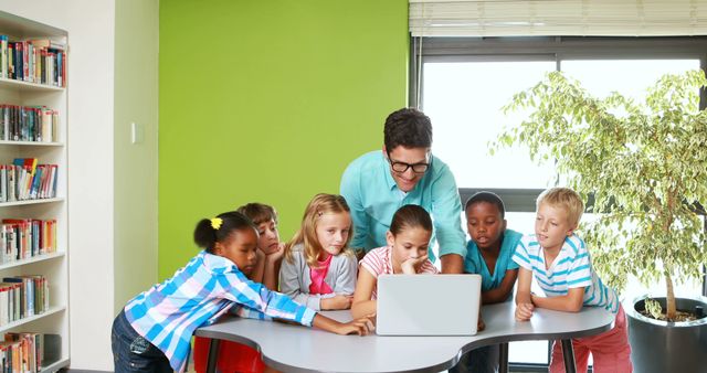 Teacher Guiding Curious Classroom of Children in modern Library - Download Free Stock Images Pikwizard.com