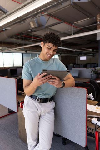 Young professional using tablet in open office concept