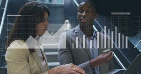 Professionals analyzing data on office stairwell