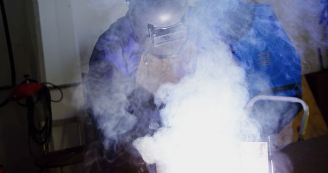 Welder Shrouded in Smoke While Working with Bright Spark - Download Free Stock Images Pikwizard.com