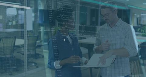Business professionals analyzing code in corporate office