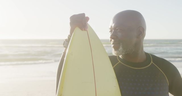 Elderly Surfer Holding Surfboard at Beach Sunset - Download Free Stock Images Pikwizard.com