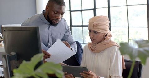 Effective Business Team Discussing Documents in Modern Office