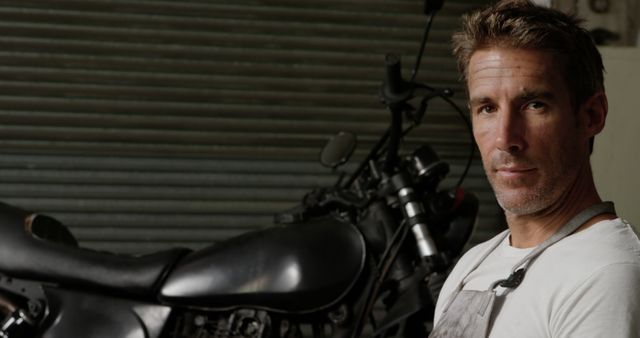 Confident Mechanic Next to Motorcycle in Workshop - Download Free Stock Images Pikwizard.com