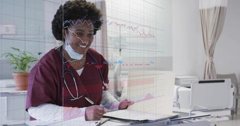 Black nurse reviewing patient chart with digital health data overlays in clinic exam room