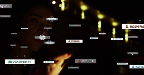 Holding smartphone, woman tapping floating numeric data tags on dark urban interface