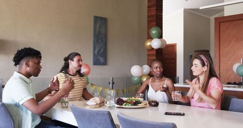 Friends laughing at celebration sharing meals and memories