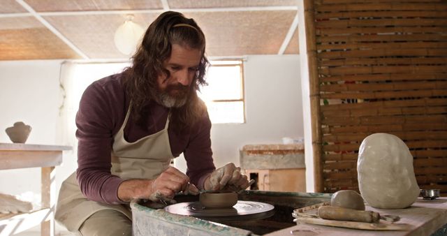 Male Artisan Crafting Pottery on Spinning Wheel in Art Studio - Download Free Stock Images Pikwizard.com