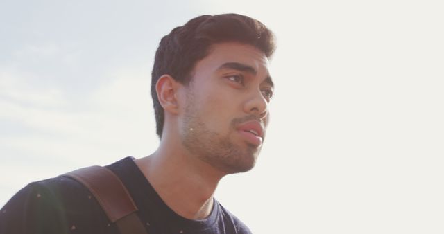 Young Man Looking Thoughtful in Natural Light Outdoors - Download Free Stock Images Pikwizard.com