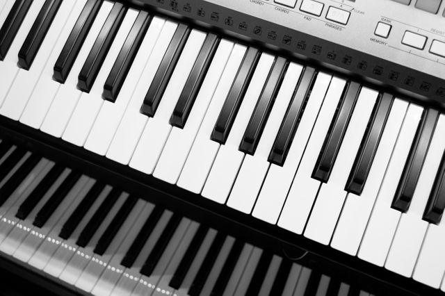 Perfect for articles on music and technology, this image highlights the depth and complexity of both digital and traditional pianos. Great for use in music tutorial blogs, electronic music product advertisements, or as background visuals for music software.