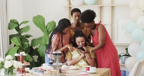 Women Celebrating Together at Home with Selfies and Laughter