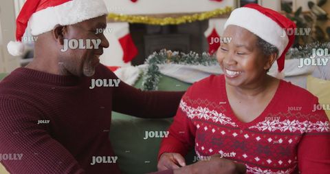 Senior Black Couple Celebrating Christmas in Santa Hats