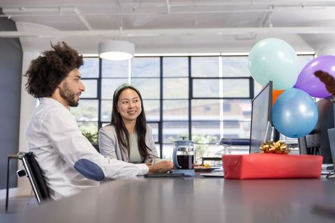 Diverse Coworkers Celebrating at Office with Gift and Balloons