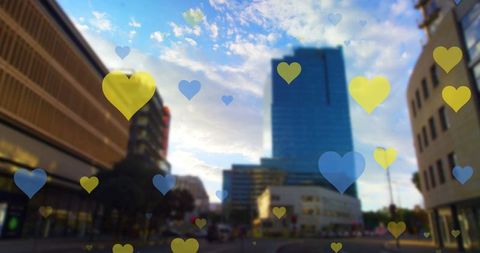 Yellow and Blue Heart Symbols Over Modern Cityscape - Download Free Stock Images Pikwizard.com