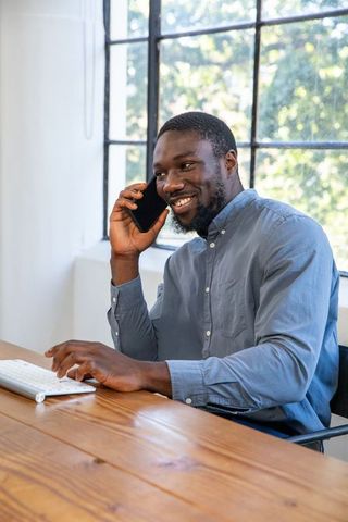 Professional Man on Phone Working at Bright Modern Office Desk