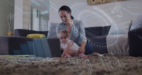 Mother holding baby using laptop on living room rug with futuristic hud overlay