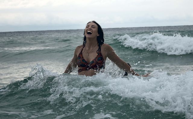 Young Woman Laughing Joyfully in Ocean Waves - Download Free Stock Photos Pikwizard.com