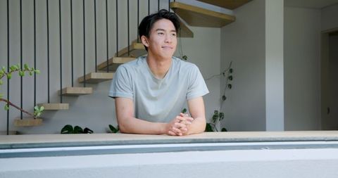 Relaxed Young Man Enjoying Modern Minimalist Living Space