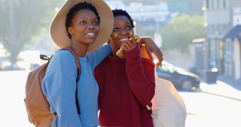 Twin Sisters Relaxing in Urban City in Warm Attire