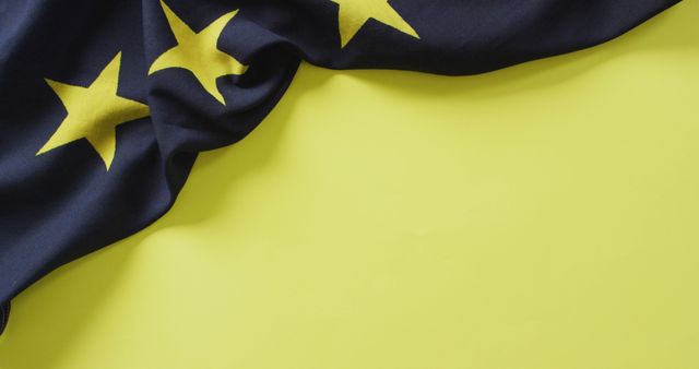 Close-Up of European Union Flag Draped on Yellow Background - Download Free Stock Images Pikwizard.com
