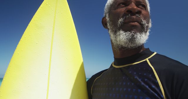 Elderly Man with Surfboard Enjoying Sunny Beach - Download Free Stock Images Pikwizard.com