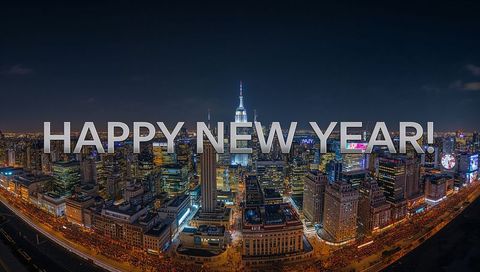 Celebrating New Year with Bold Overlay over Illuminated Downtown Skyline at Night