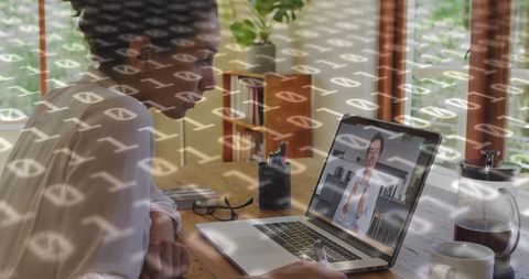 Binary Codes Overlaying Businesswoman in Video Call on Laptop