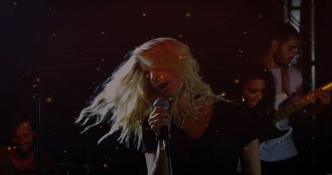 Blonde Lead Vocalist Performing with Indie Band on Moody Small Stage Spotlight