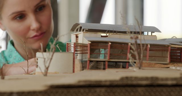 Female Architect Examining Miniature Building Model in Studio - Download Free Stock Images Pikwizard.com