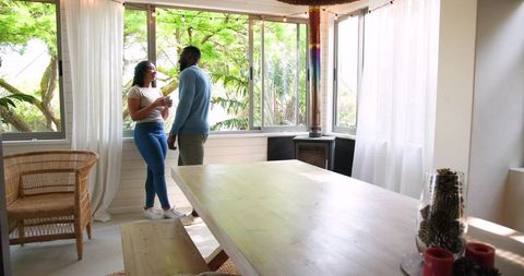 Relaxed couple enjoying conversation in bright modern living room