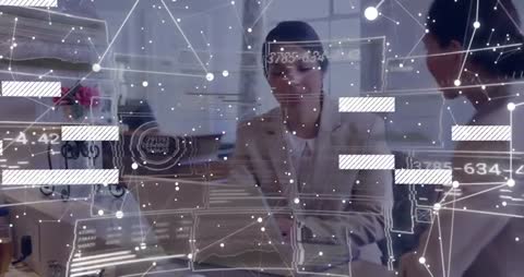 Colleagues Collaborating with Data Analytics Visuals at Workplace