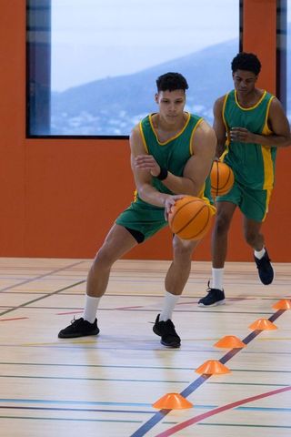Athletes Dribbling Basketballs Through Cones for Agility Training