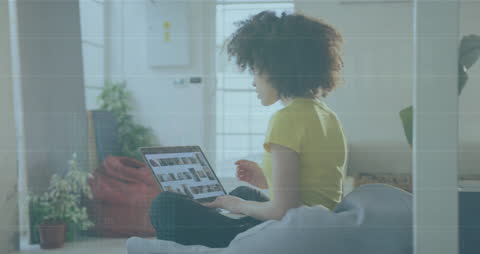 Young Woman Analyzing Data on Laptop at Home