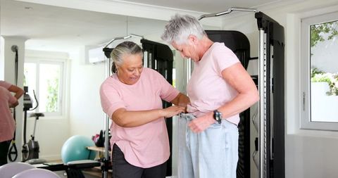 Senior Lesbians Laughing Together During Private Home Workout