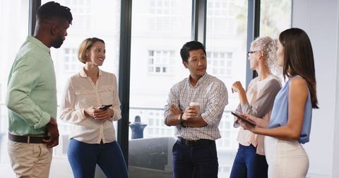 Diverse Team Collaborating on Project Ideas in Modern Office