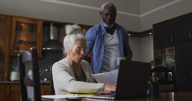 Elderly Couple Managing Finances Together in Cozy Kitchen - Download Free Stock Images Pikwizard.com