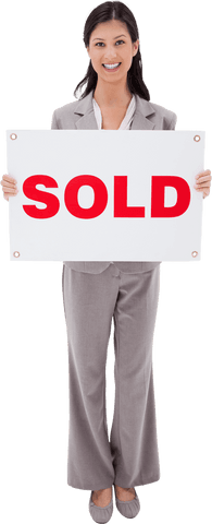 Smiling business woman holding transparent sold sign