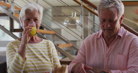 Elderly Couple Enjoying Breakfast at Home, Vibrant Conversation