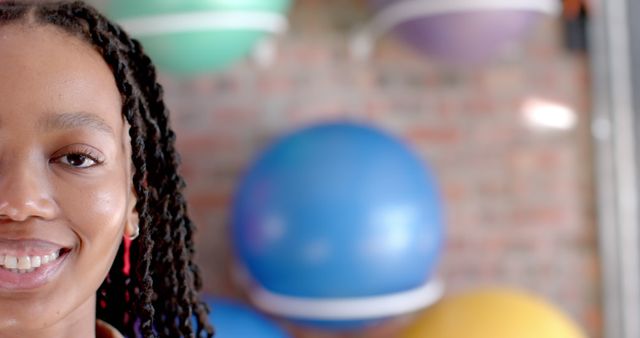 Young Woman Smiling with Exercise Balls in Background - Download Free Stock Images Pikwizard.com